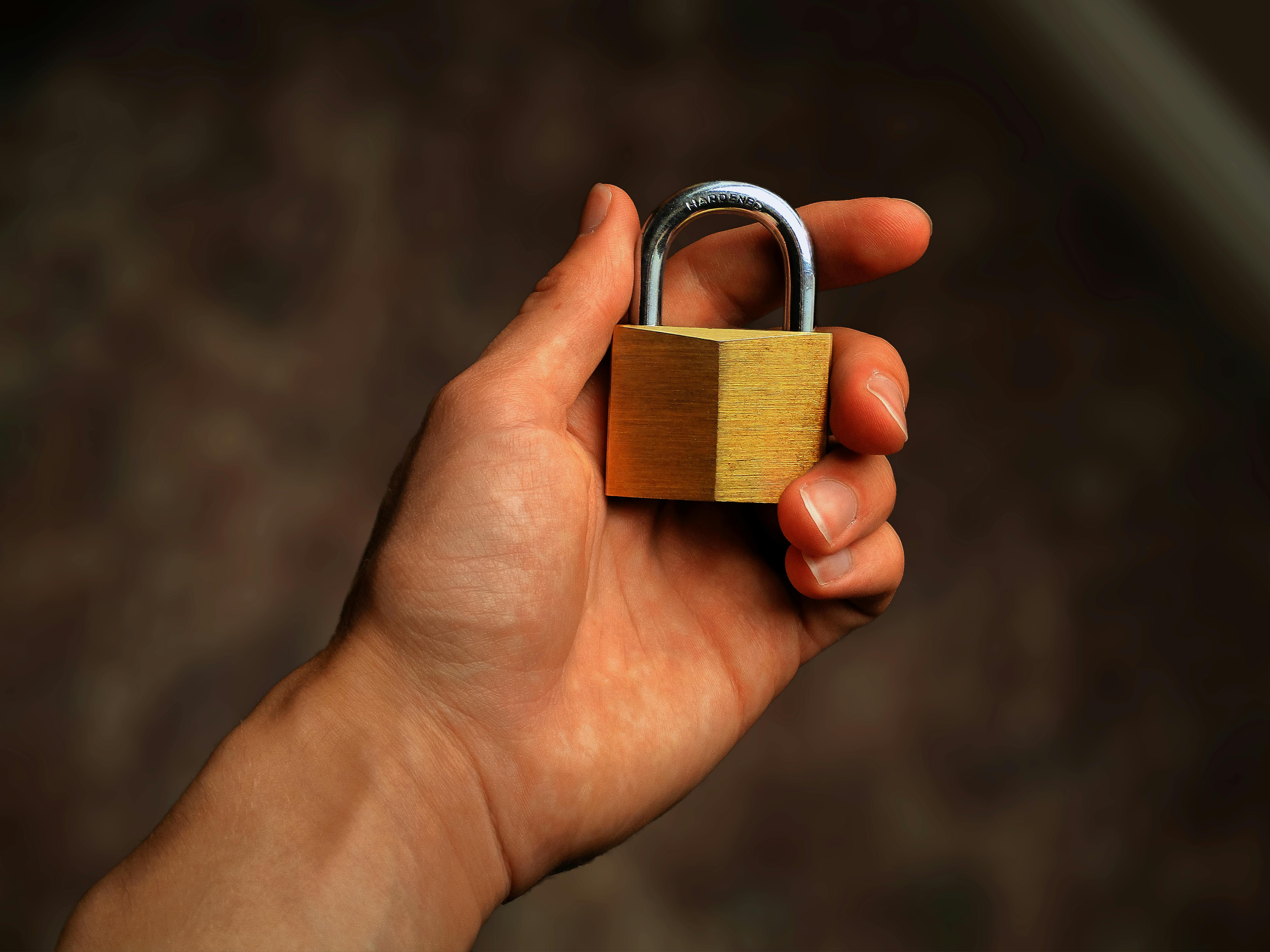 Hand houdt een gesloten hangslot vast als symbool voor e-mailbeveiliging met SPF, DKIM en DMARC